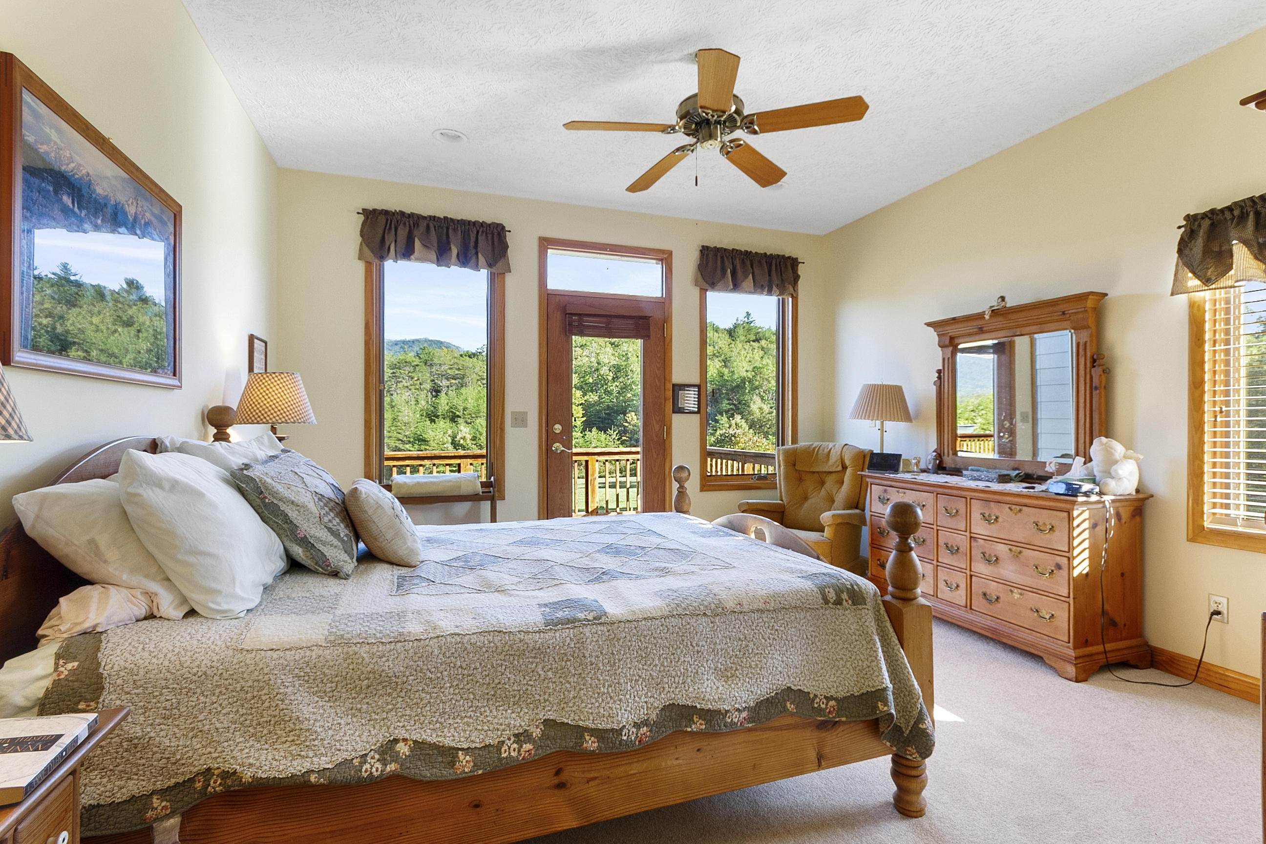 3950 Flatwoods Road Elliston, VA 24087 - Photo 23 of 94 a bedroom with a bed a large window and a chandelier