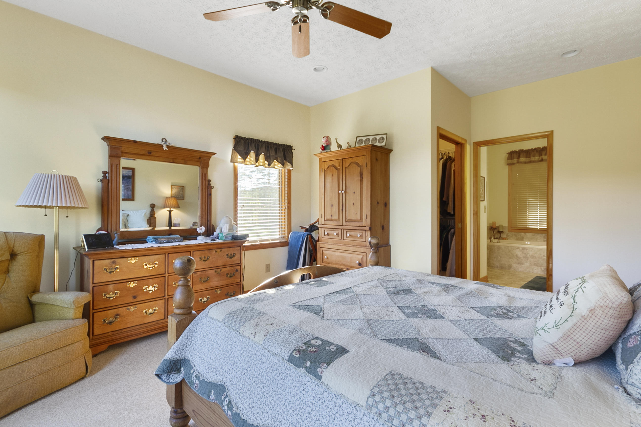 3950 Flatwoods Road Elliston, VA 24087 - Photo 25 of 94 a bedroom with a bed a couch and dresser