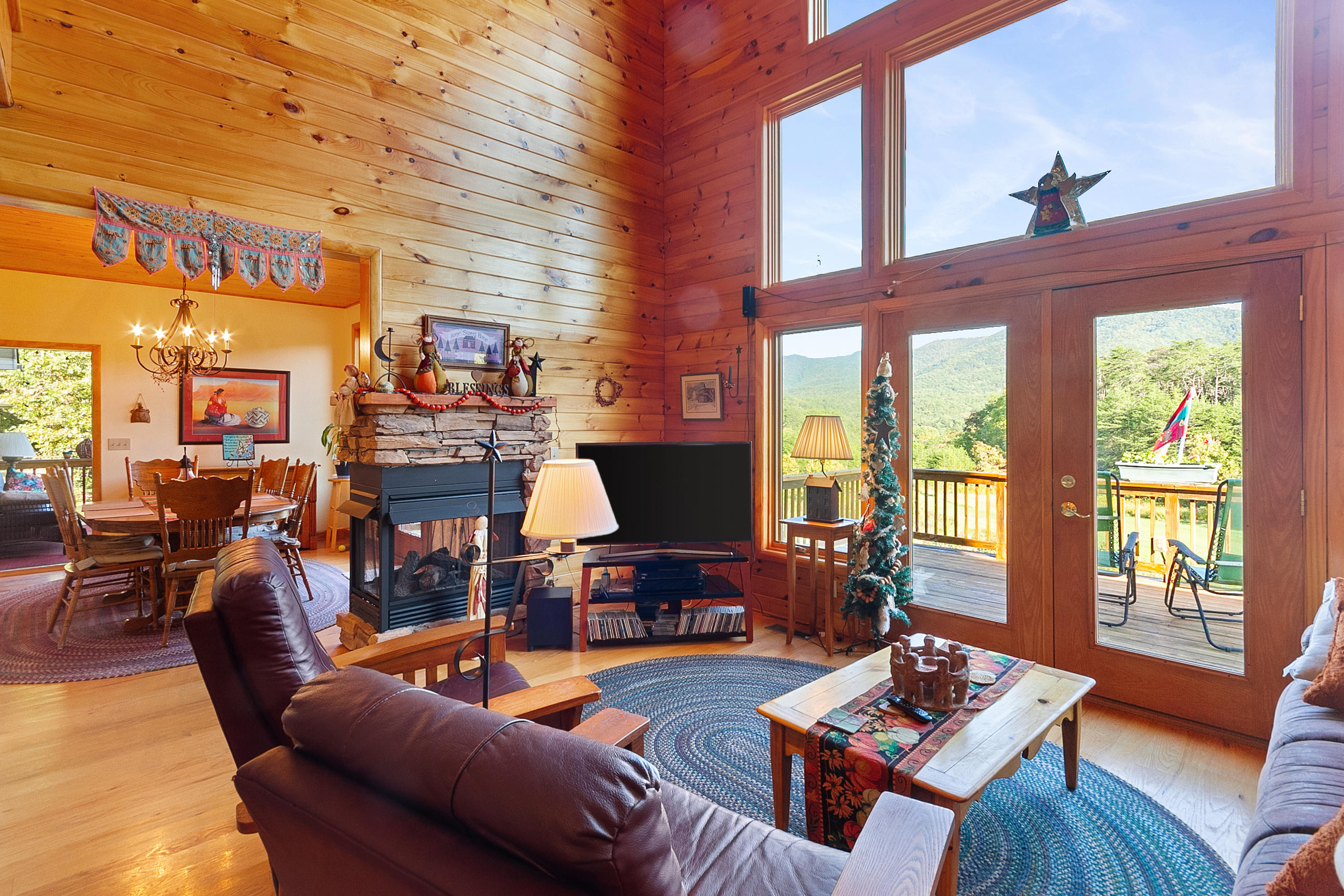 3950 Flatwoods Road Elliston, VA 24087 - Photo 31 of 94 a living room with furniture a fireplace and large windows