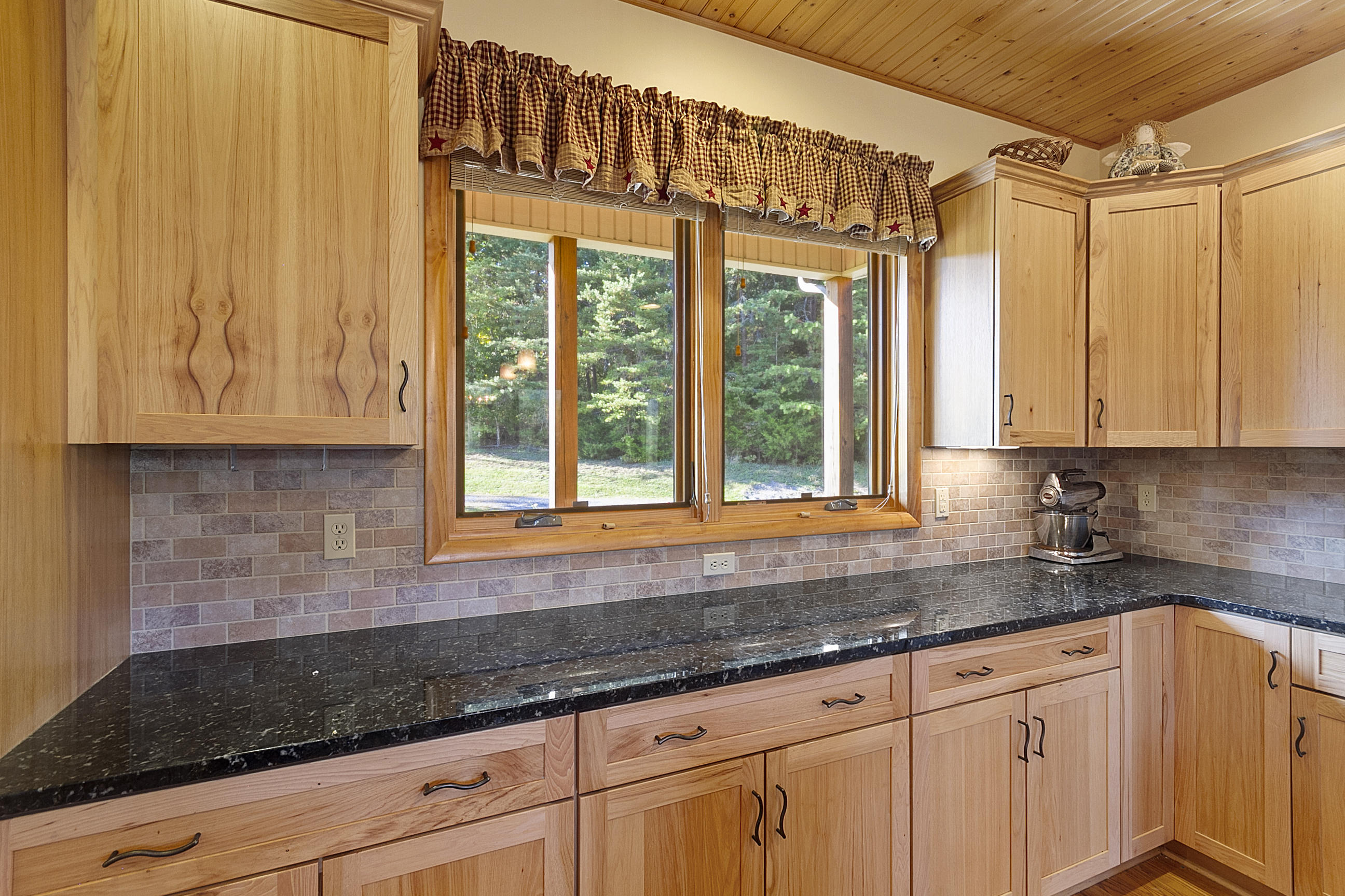 3950 Flatwoods Road Elliston, VA 24087 - Photo 47 of 94 a kitchen with granite countertop a sink window and cabinets