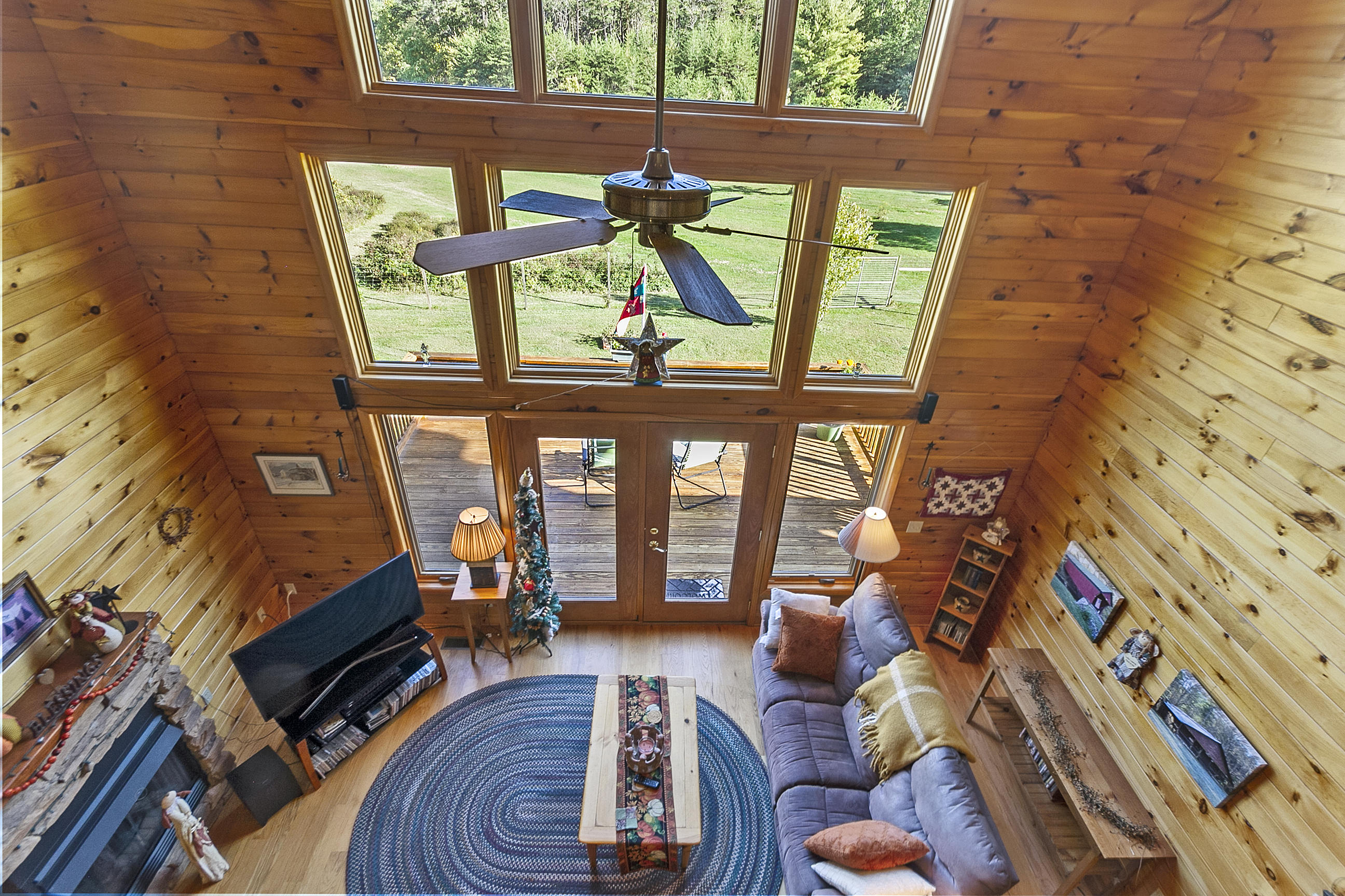 3950 Flatwoods Road Elliston, VA 24087 - Photo 53 of 94 a living room with furniture a fireplace and a floor to ceiling window