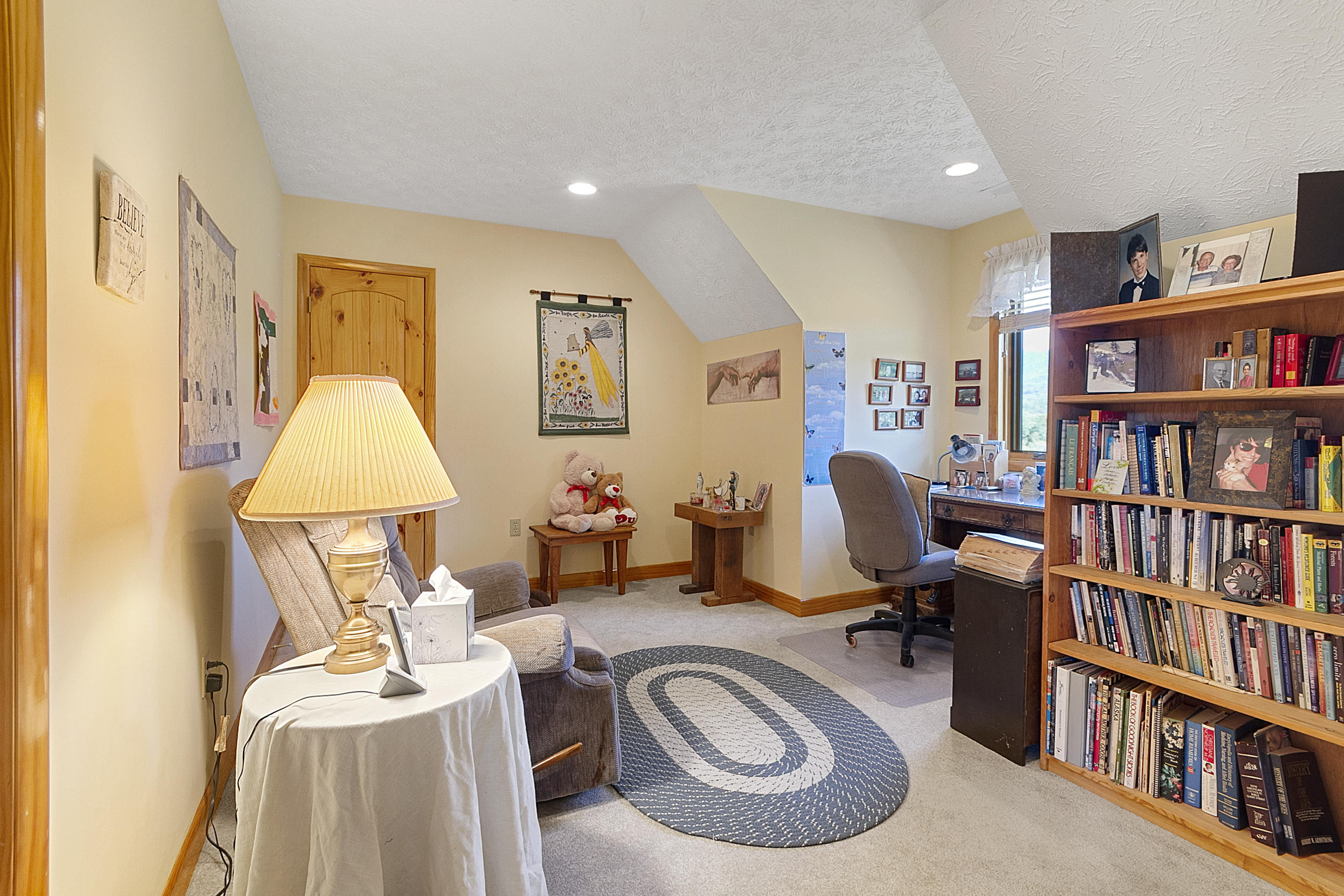 3950 Flatwoods Road Elliston, VA 24087 - Photo 56 of 94 a view of a workspace with furniture and a book shelf