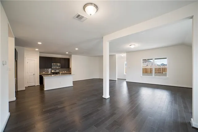 a view of kitchen with cabinets and wooden floor