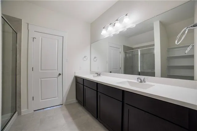 a bathroom with a double vanity sink and a mirror