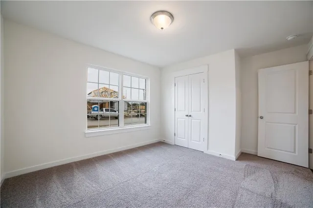 an empty room with a empty space and windows