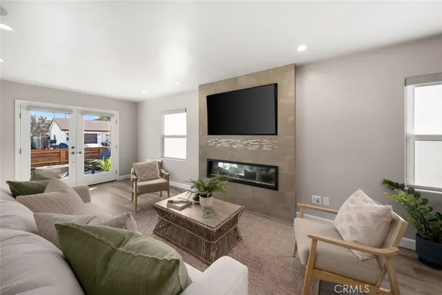 a living room with furniture a fireplace and a flat screen tv