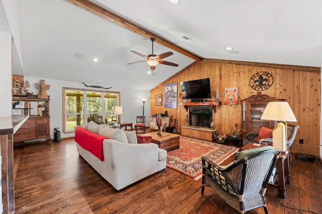 a living room with furniture fireplace and flat screen tv