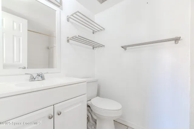 a bathroom with a sink toilet and vanity