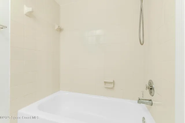 a bathroom with a white bathtub