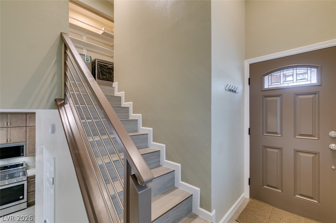 540 Sutters Mill Road Henderson, NV 89014 - Photo 10 of 46 This inviting entrance features a grand staircase and durable tile flooring.