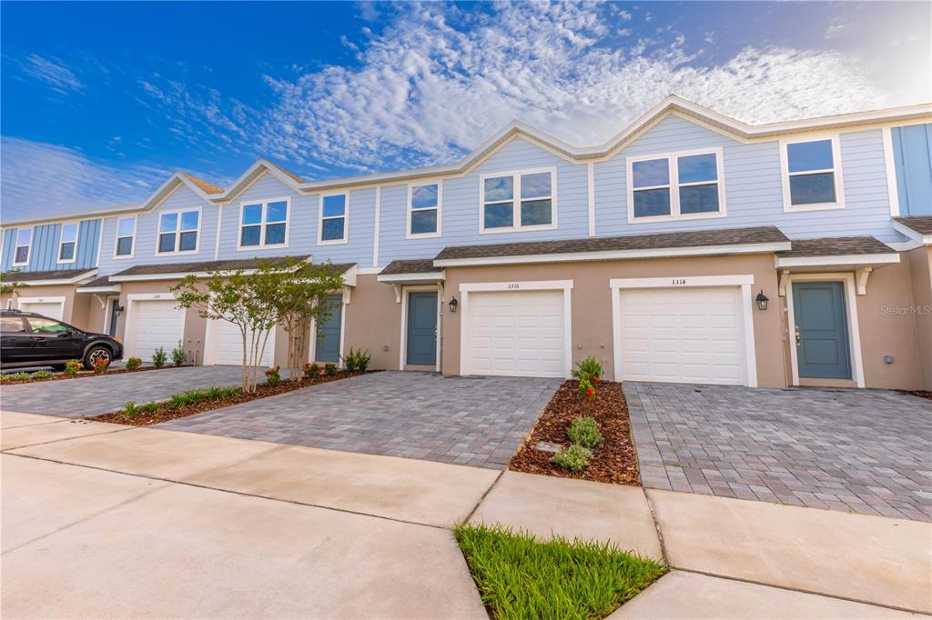 3328 Thicket Street Tavares, FL 32778 - Photo 1 of 1 a front view of a house with a yard and garage