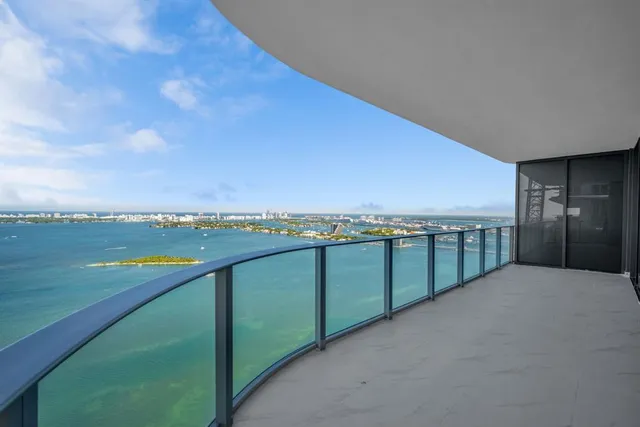 a bedroom with a bed next to a large window with outer view
