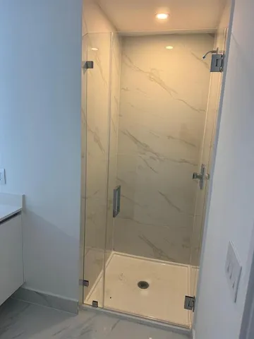 a view of bathroom with tub and window