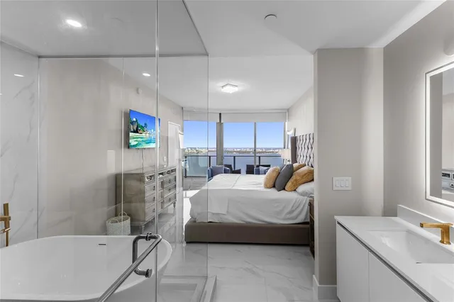 a kitchen with stainless steel appliances a sink and a refrigerator