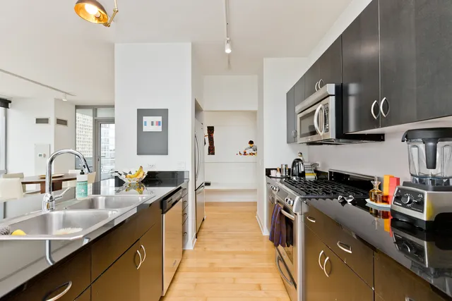 a kitchen with stainless steel appliances a stove sink and cabinets
