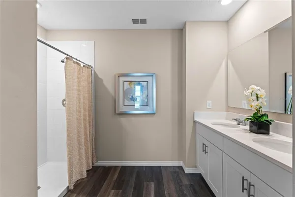 a bathroom with 2 sink and a mirror