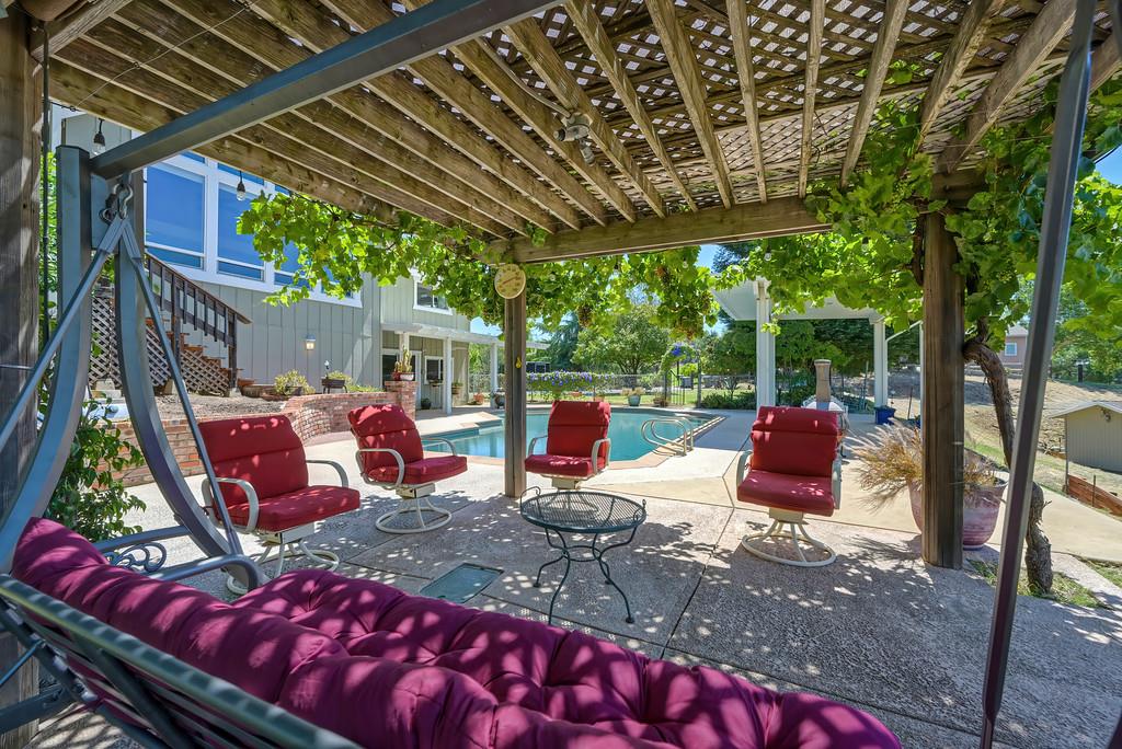 7630 Ridge Road Newcastle, CA 95658 - Photo 63 of 85 Resort-style built-in pool with multiple covered outdoor entertaining areas. Expansive poolside pavilion. Shaded outdoor lounge area. Panoramic valley, hills and pasture views. Incredible sunset views.