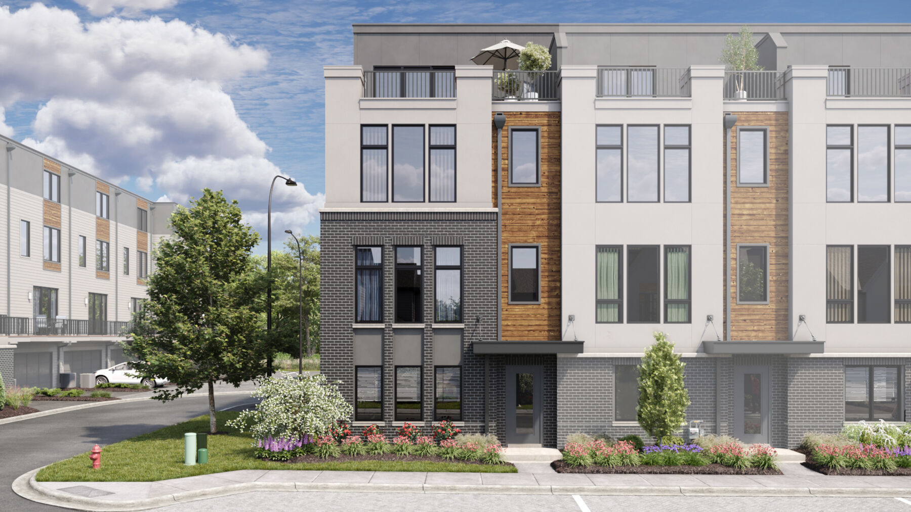 a front view of a residential apartment building with a yard