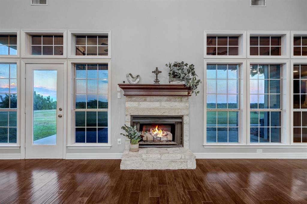1810 Longbranch Road Waxahachie, TX 76065 - Photo 15 of 39 a living room with a fireplace and windows