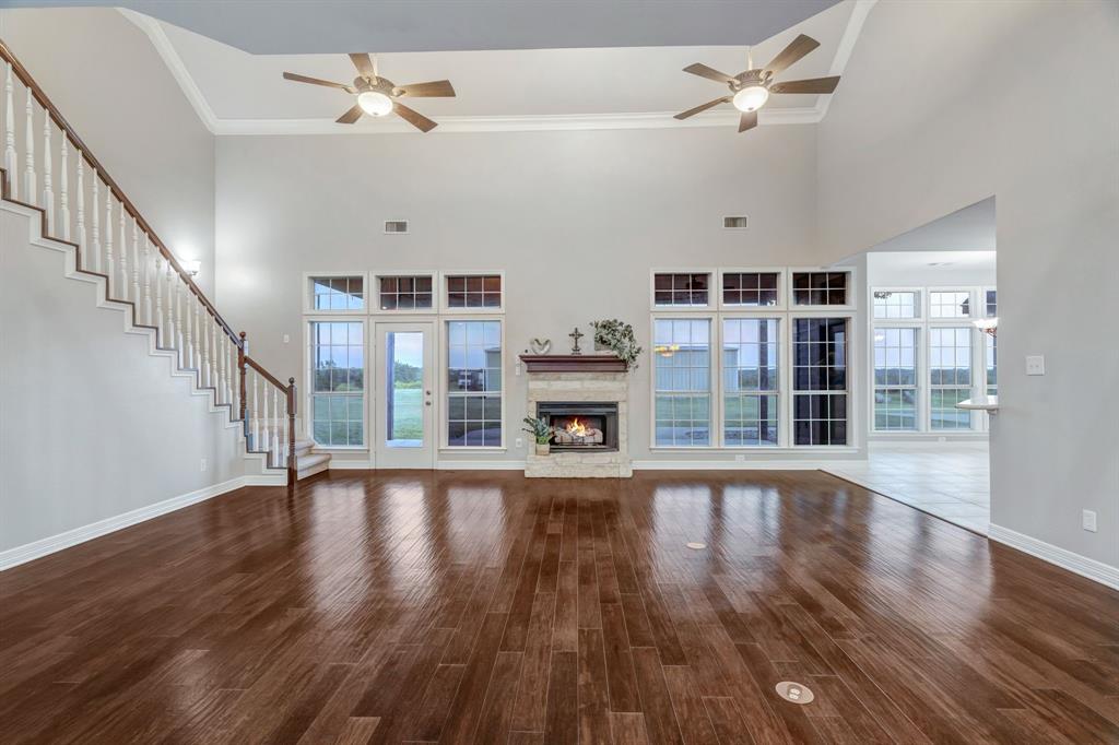 1810 Longbranch Road Waxahachie, TX 76065 - Photo 16 of 39 a view of an empty room with wooden floor and a ceiling fan