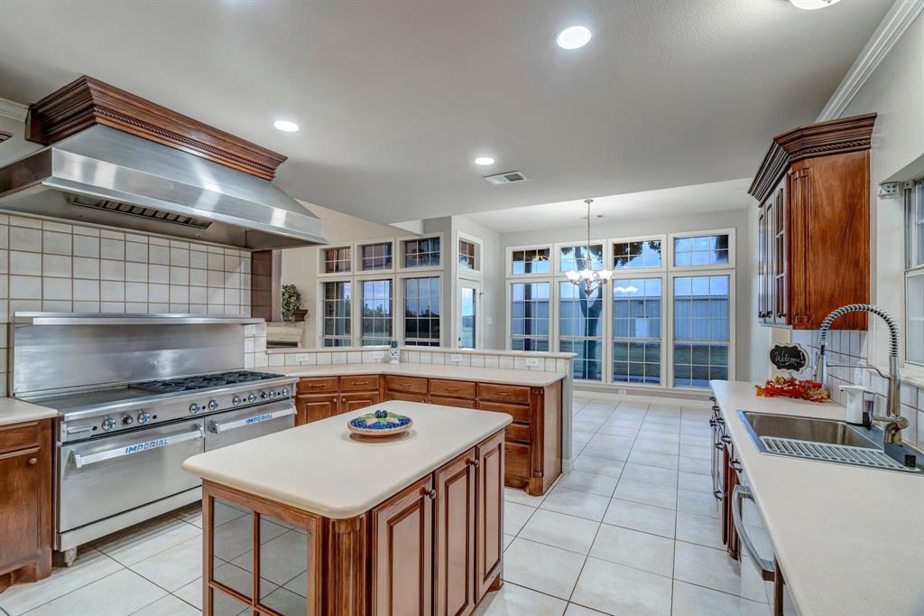 1810 Longbranch Road Waxahachie, TX 76065 - Photo 18 of 39 a kitchen with a stove a sink and a refrigerator