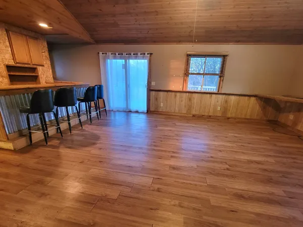 a view of kitchen with furniture and wooden floor