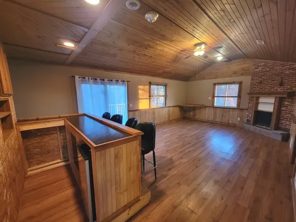 a utility room with wooden floors and pool table