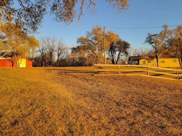 a view of outdoor space with trees in the background