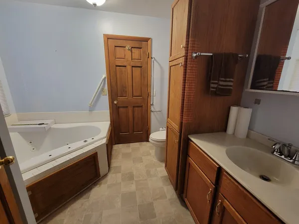 a bathroom with a sink a mirror and a bathtub