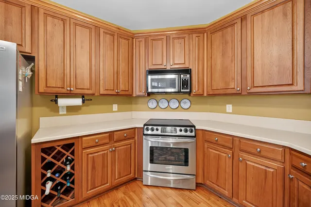 a kitchen with granite countertop a stove top oven microwave and cabinets