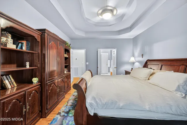 a bedroom with a bed cabinets and walk in closet