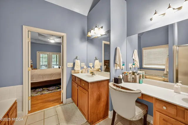 a very nice looking dining room with a large window and chandelier
