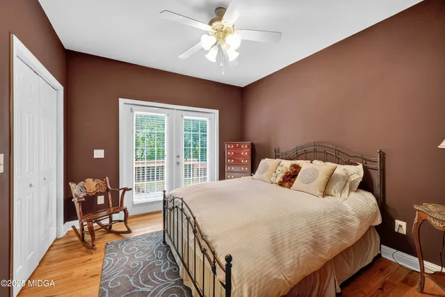 a bedroom with a bed a table and a chandelier