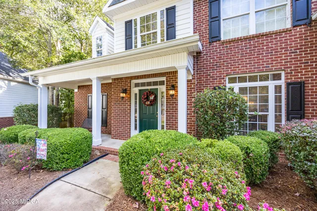 front view of a brick house with a large window