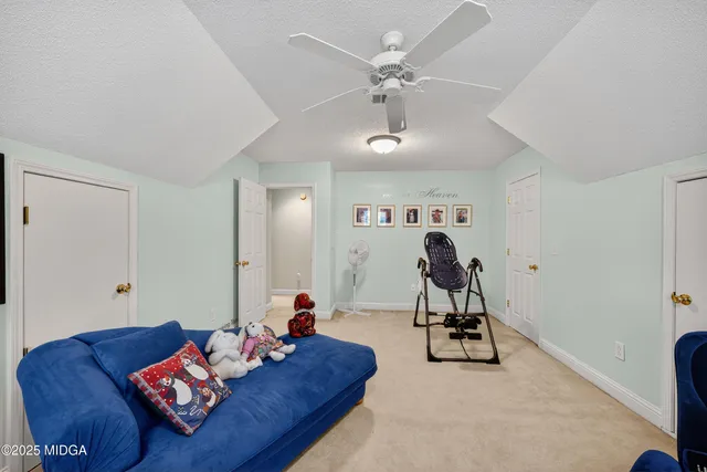 a living room with furniture a chandelier and a rug
