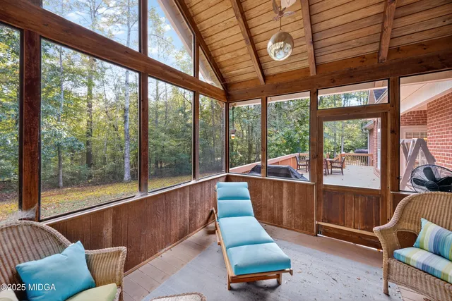 a living room with furniture and a floor to ceiling window