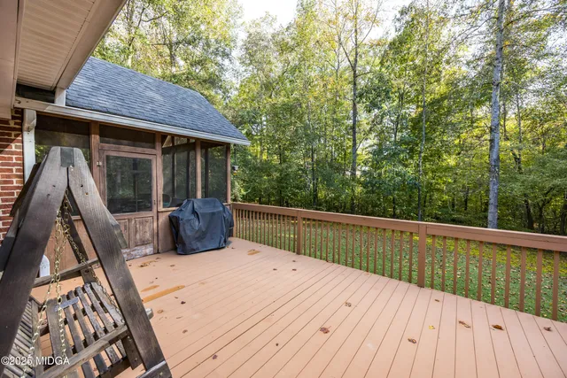 a view of backyard with roof deck and furniture