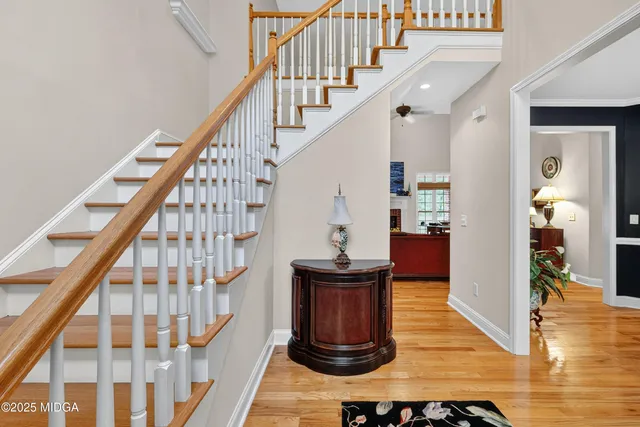 a view of entryway and hall with wooden floor