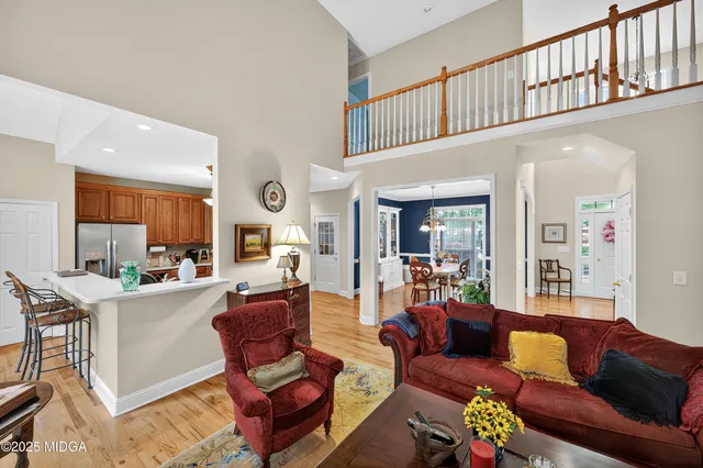 a living room with fireplace furniture and a dining table