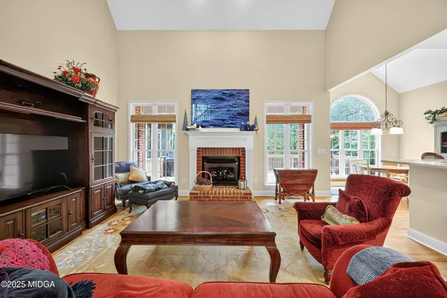 a living room with furniture fireplace and flat screen tv