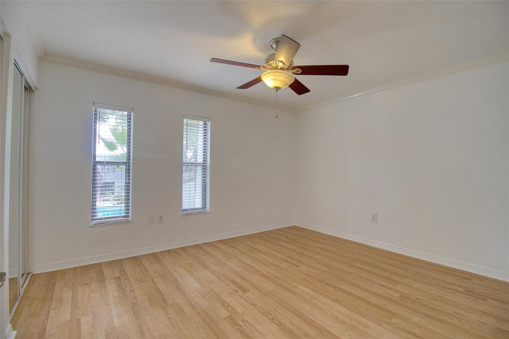 702 Lyndhurst Street, Unit 821 Dunedin, FL 34698 - Photo 15 of 30 a view of empty room with wooden floor and fan