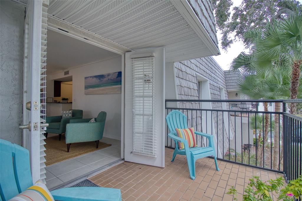 702 Lyndhurst Street, Unit 821 Dunedin, FL 34698 - Photo 18 of 30 a view of a deck with chair and potted plant
