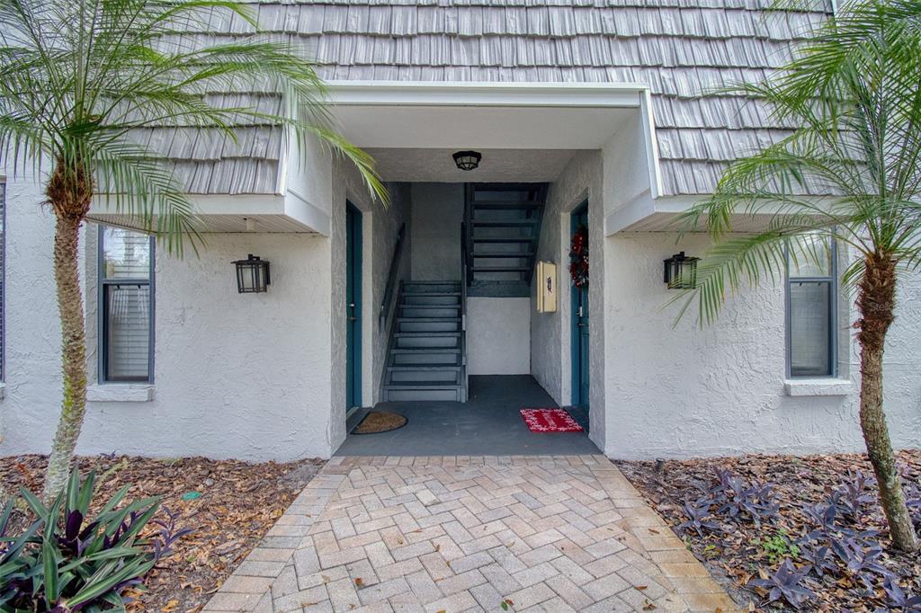 702 Lyndhurst Street, Unit 821 Dunedin, FL 34698 - Photo 2 of 30 a view of a house with a yard