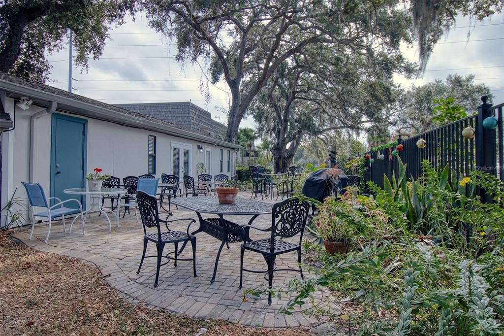 702 Lyndhurst Street, Unit 821 Dunedin, FL 34698 - Photo 24 of 30 a view of a patio with furniture and table and chairs