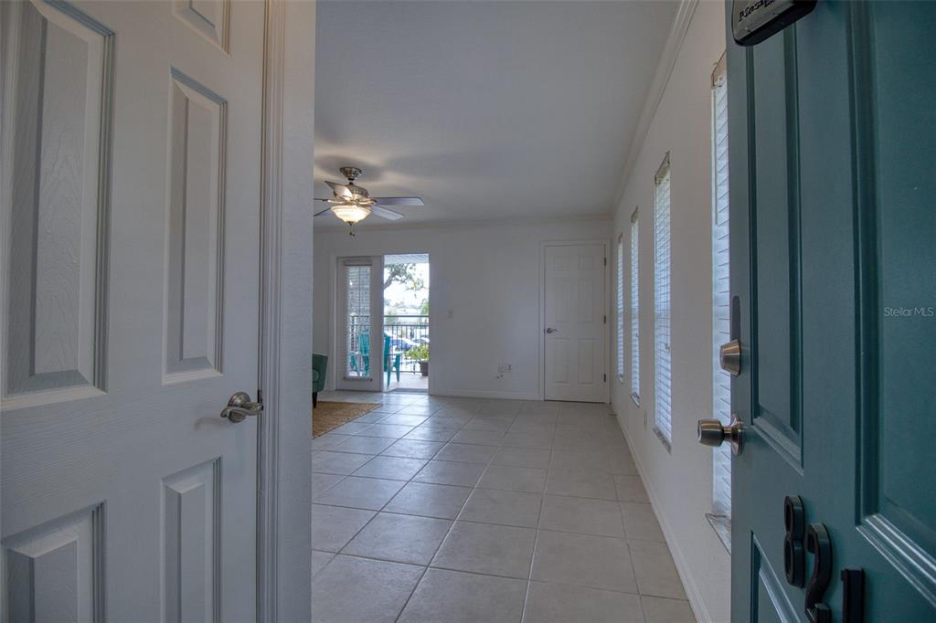 702 Lyndhurst Street, Unit 821 Dunedin, FL 34698 - Photo 3 of 30 a view of a hallway with windows and brick walls