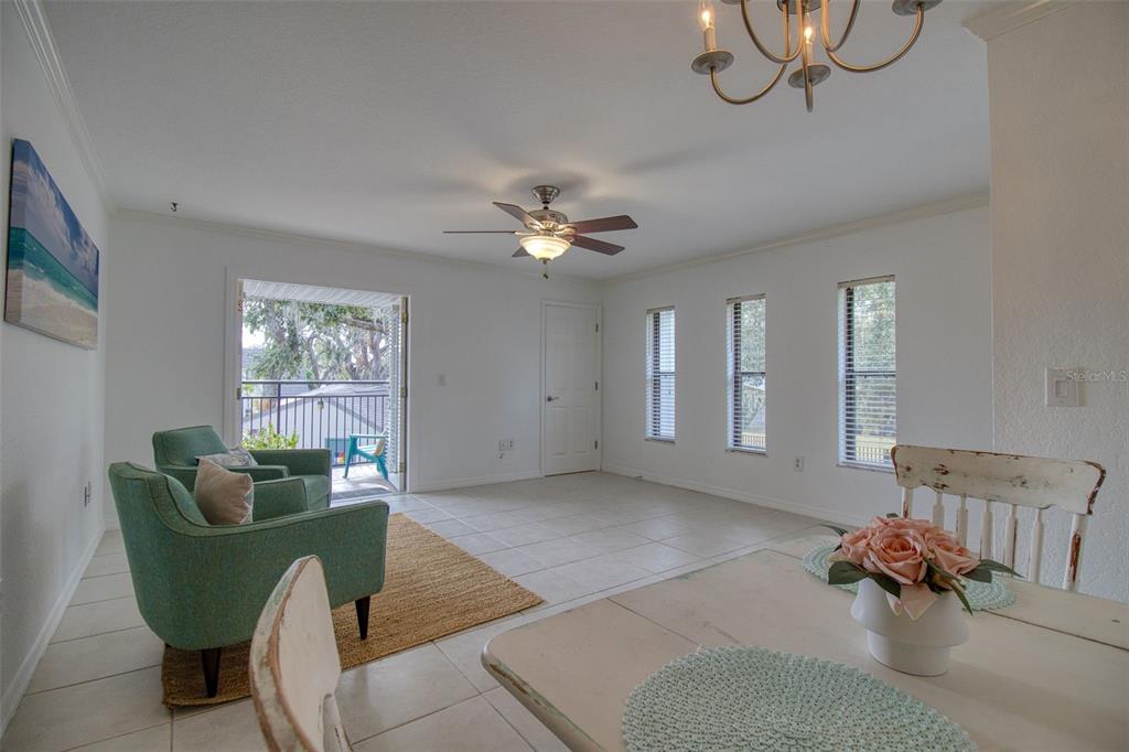702 Lyndhurst Street, Unit 821 Dunedin, FL 34698 - Photo 8 of 30 a living room with furniture and a window