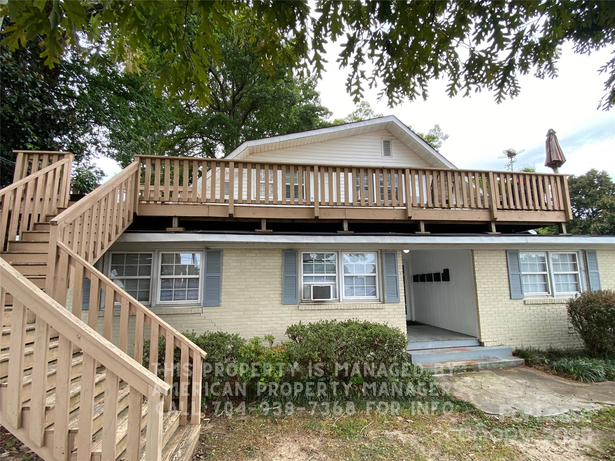 1110 South Main Street, Unit 1 Kannapolis, NC 28081 - Photo 1 of 7 a view of a house with wooden deck and furniture