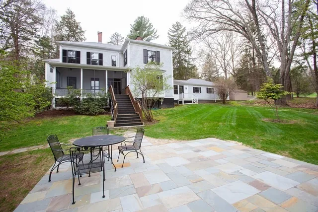 a view of a house with a yard porch and sitting area