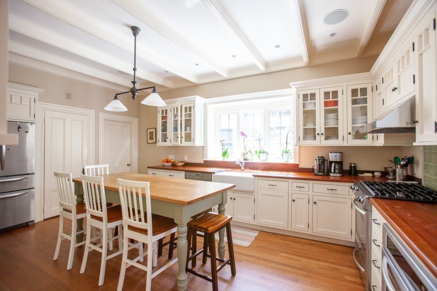 62 Pond Road Wellesley, MA 02482 - Photo 2 of 14 a kitchen with stainless steel appliances a center island wooden floor and a window