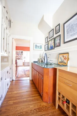 a large kitchen with stainless steel appliances granite countertop a large counter top and a view of living room